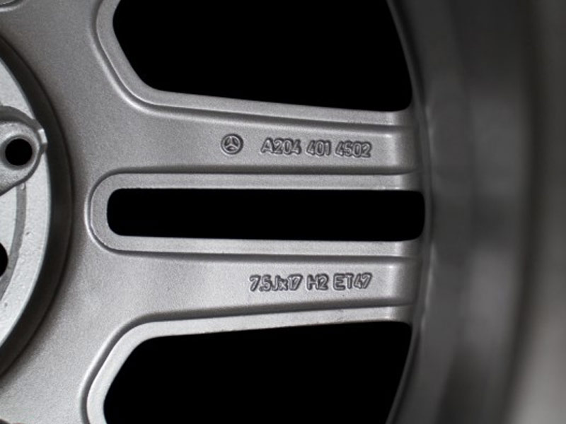 Image showing the reverse of a wheel with the Mercedes Benz logo, it’s part number and specs.